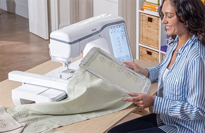 Image of the a lady sitting at the Brother Celeste CX1e Embroidery machine