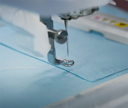 Image of the drop-light LED pointer on a Brother CX1e Embroidery machine.