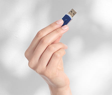 Image of a person holding a USB storage device