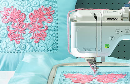 Image of the Brother Stellaire Innov-is XE2 embroidery machine stitching a built-in embroidery couching design and a finished cushion with the same design