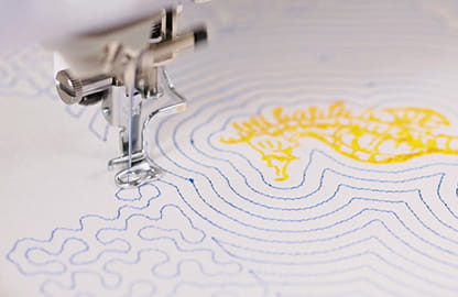 Image of the Brother Stellaire Innov-is XE2 Embroidery machine stitching a Built-in Deco-fill design