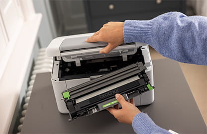 woman inserting toner into printer