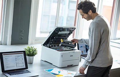 man next to laser printer