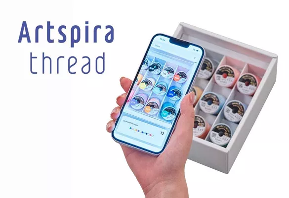 image of a person scanning the 2D codes for Brother Artspira Threads