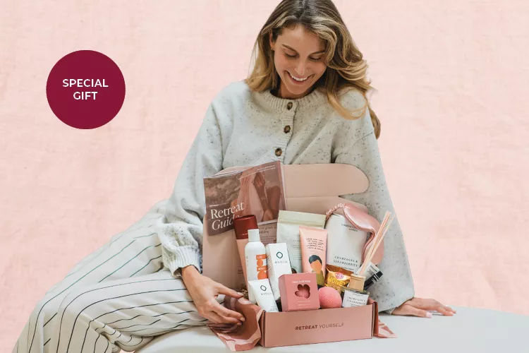 Image of a seated lady looking at the bonus offer Pamper box GWP contents for the Brother 2026 Mother's Day promotion