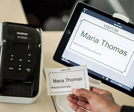 hand holding printed name label