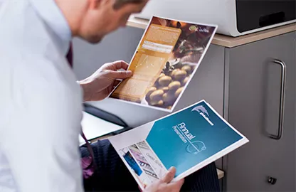 man looking at coloured print-outs