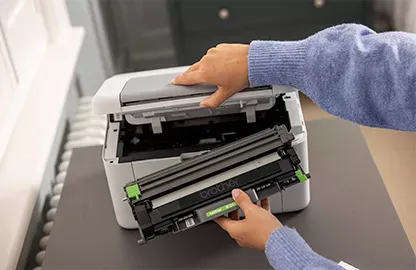 woman inserting toner into printer