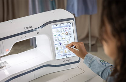 Image of the Brother Celeste CX1e Embroidery machine with a lady interacting with the large 10.1" interactive screen