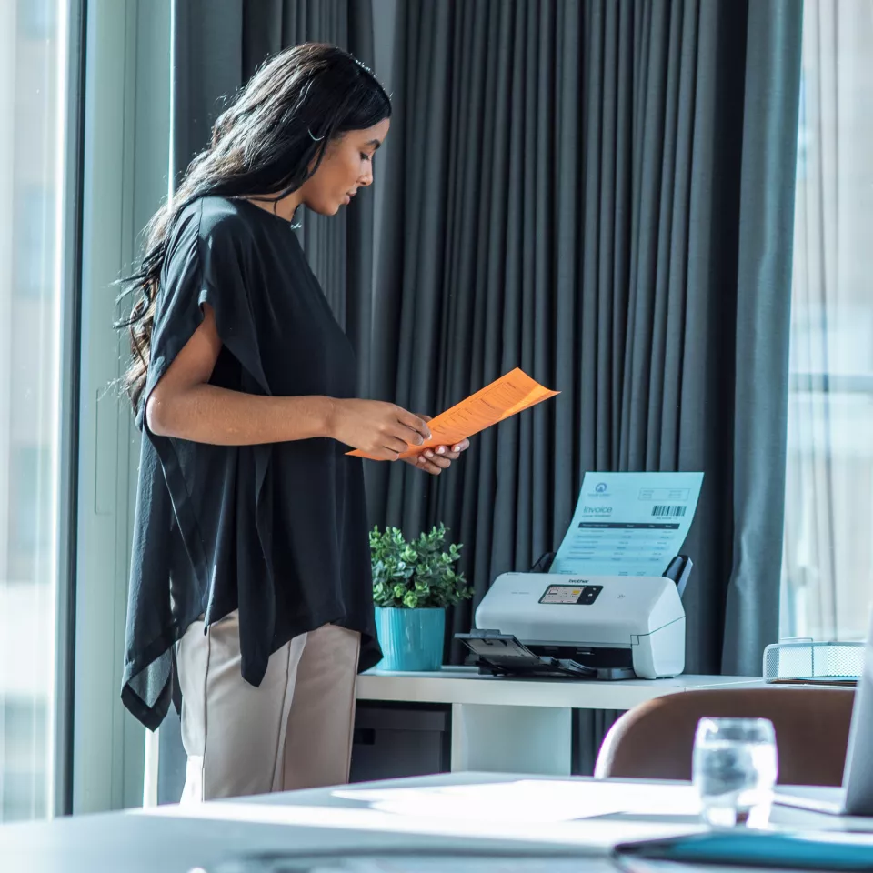 ADS-3300W sitting on a desk with a person using it