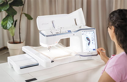 Image of the Brother Celeste CX1e Embroidery machine with a lady interacting with the large 10.1" interactive screen
