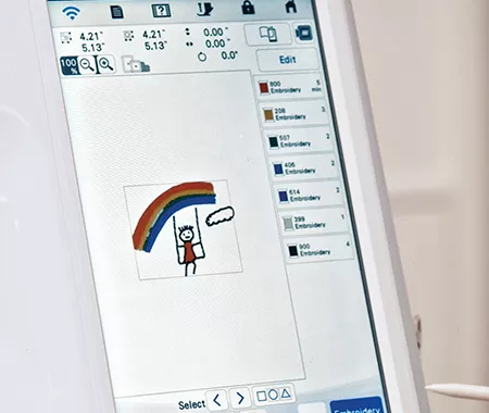 Image of the Brother Stellaire Innov-is XE2 screen depicting a hand drawn image of a rainbow and child on a swing that has been converted to embroidery