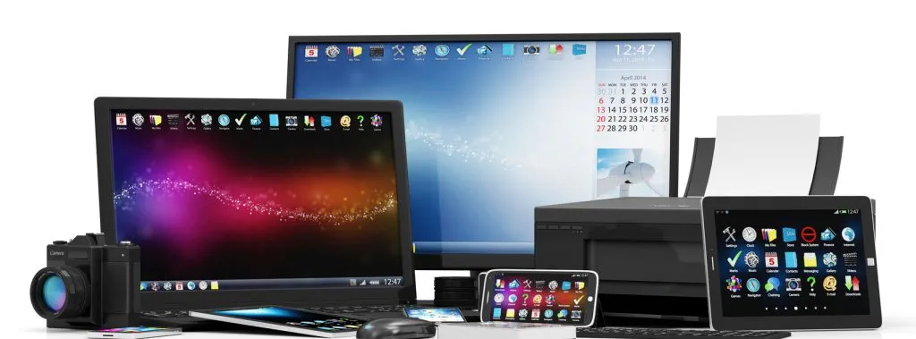 An array of home office tools such as a computer, laptop, camera, printer, tablet and smartphone. 