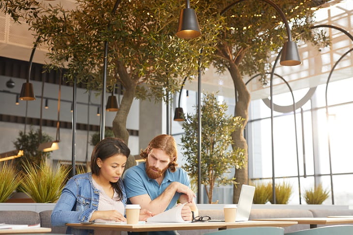 Young business people examining documents together